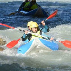 2 people canoe rafting on a river