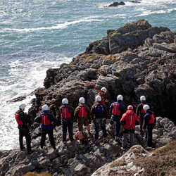 A group of people coasteering