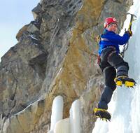 A man ice climbing