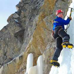 A man ice climbing