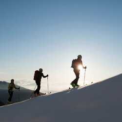 People ski touring on a mountain