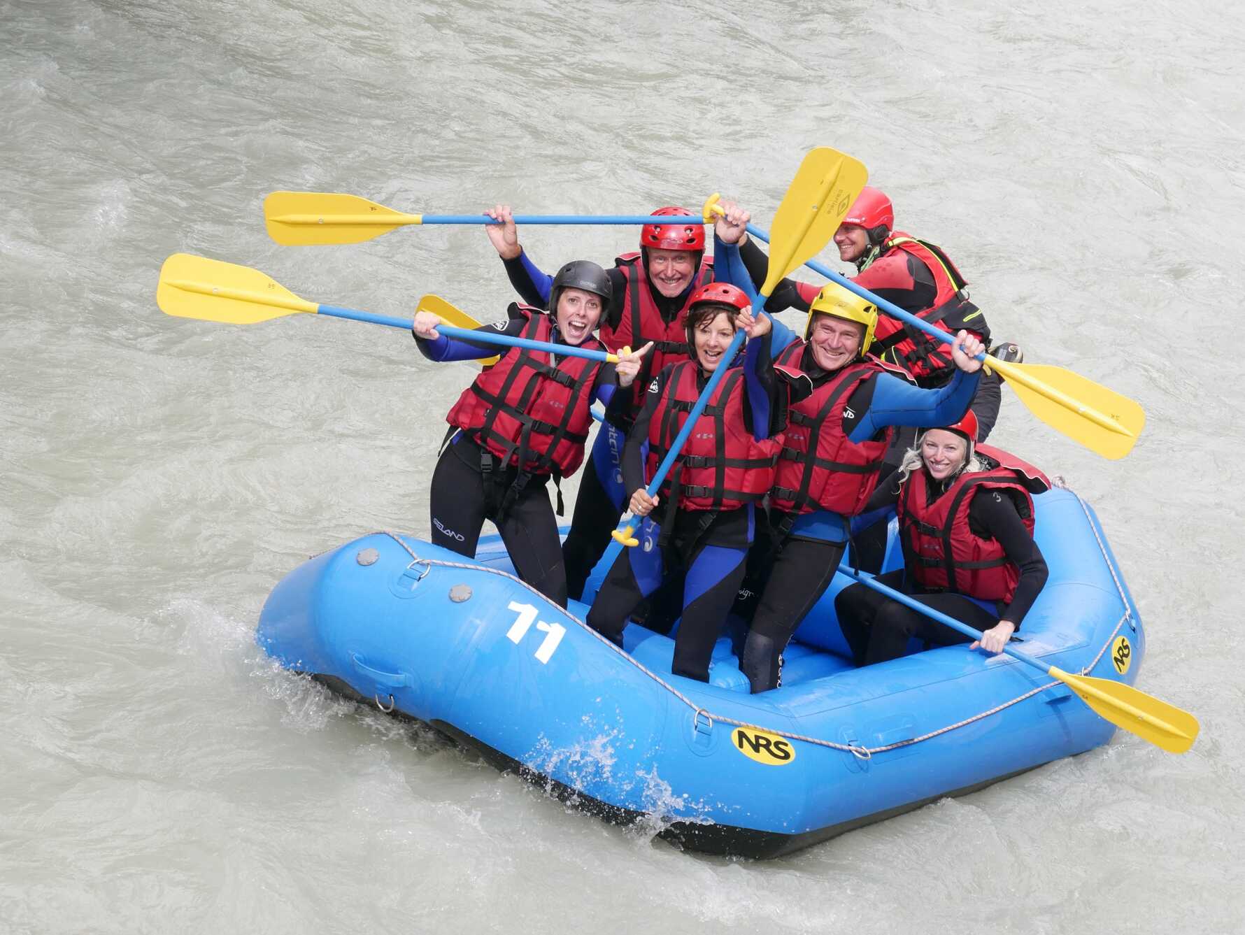 A group of people white water rafting