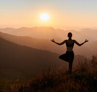 A person doing yoga in the mountains