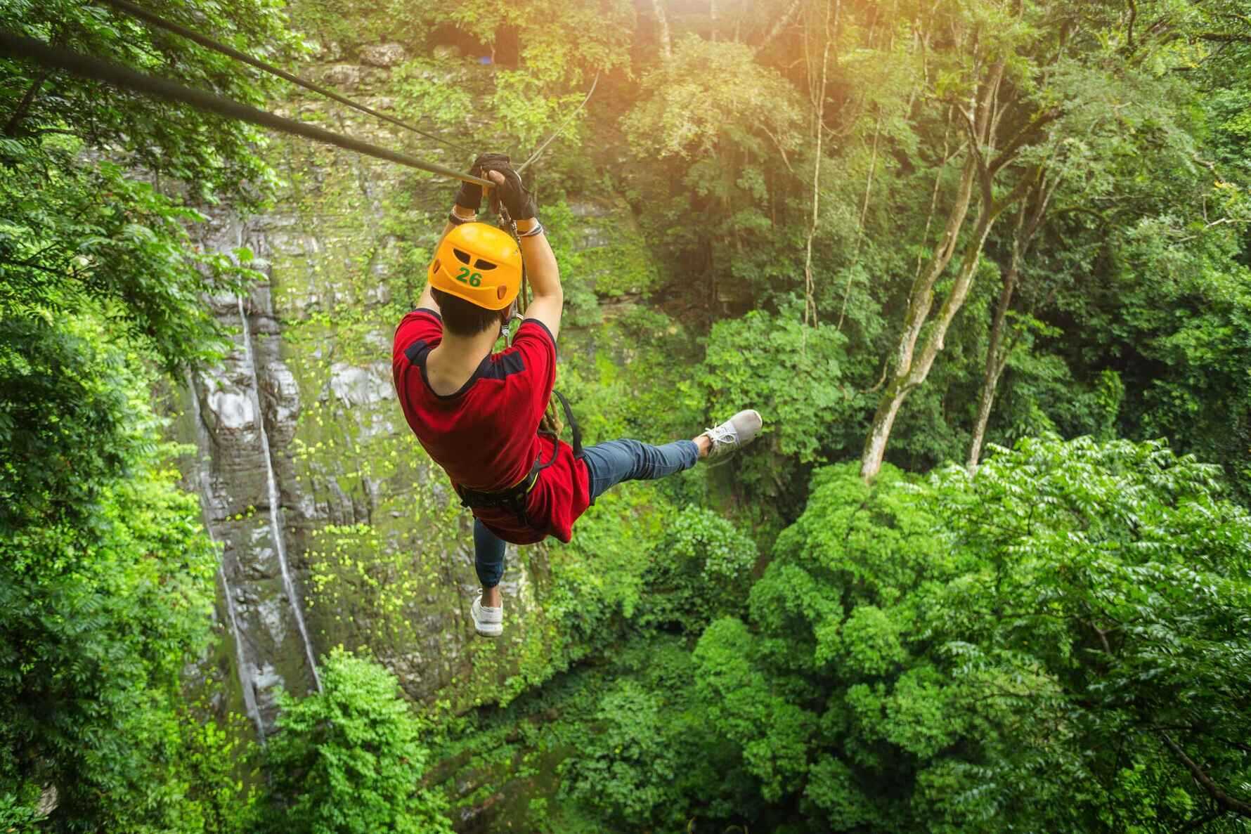 A boy zip lining in the forest