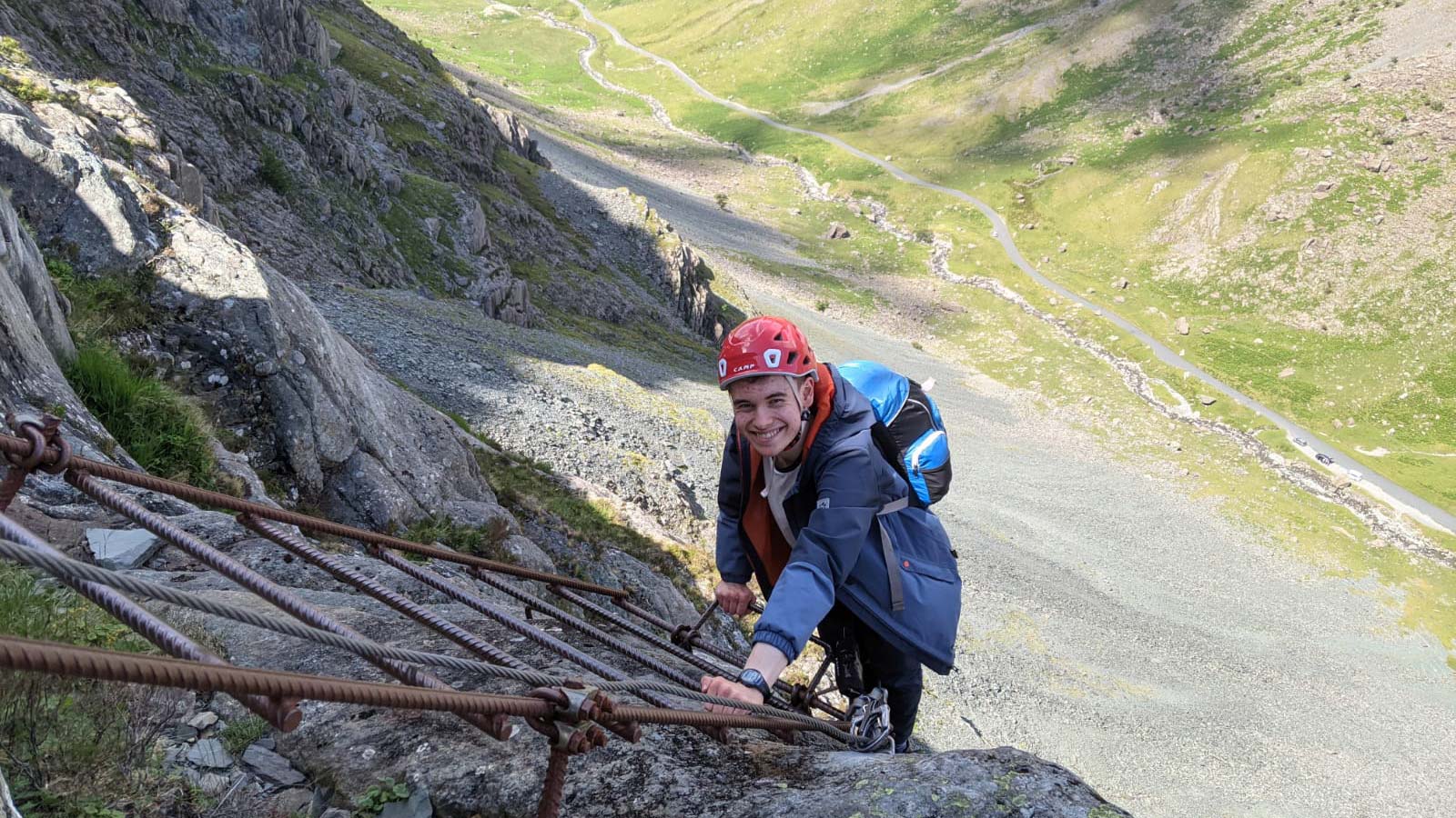 man climbing up a ladder in the hills