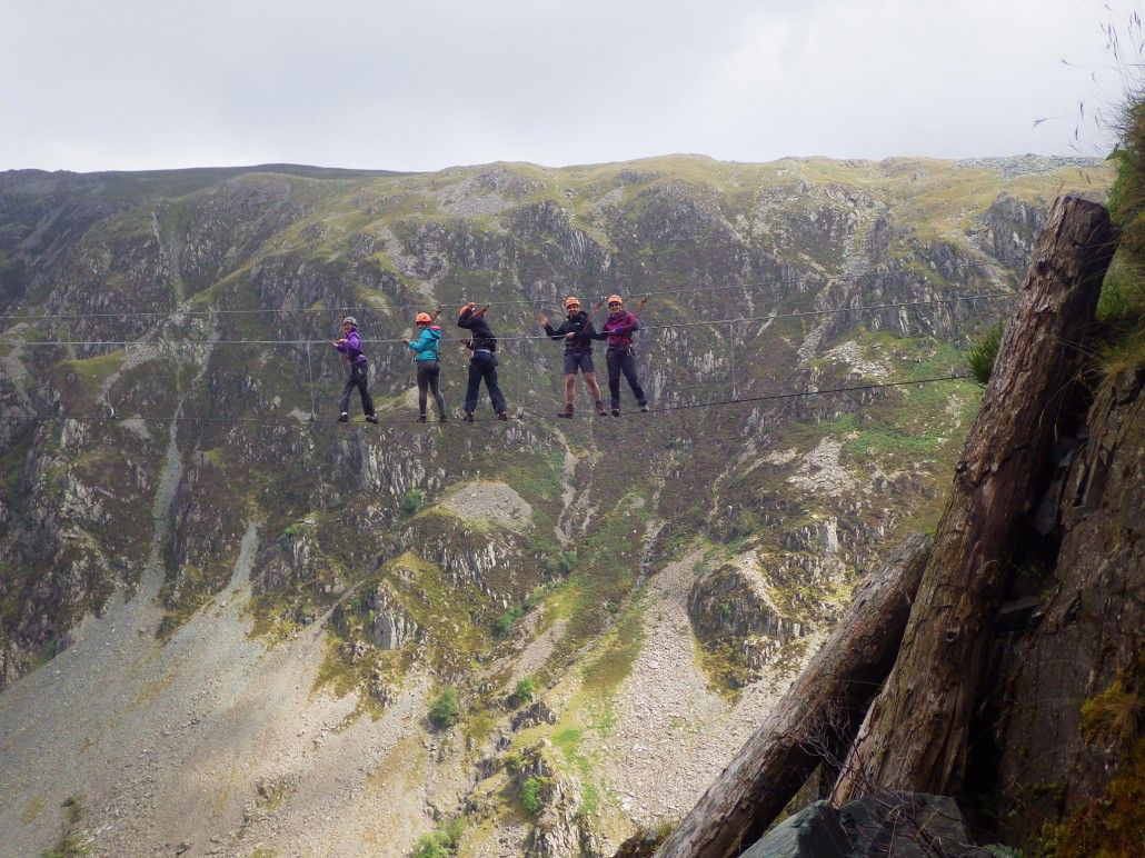 Five people standing on the Infinity Bridge in the Lake District